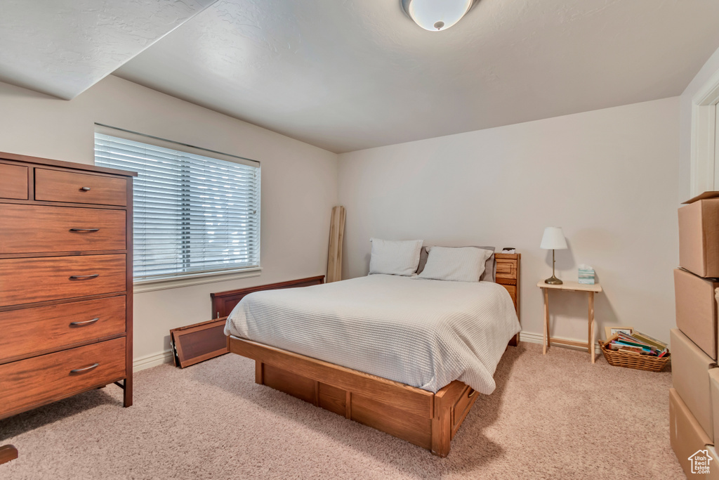 Bedroom featuring light colored carpet and baseboards