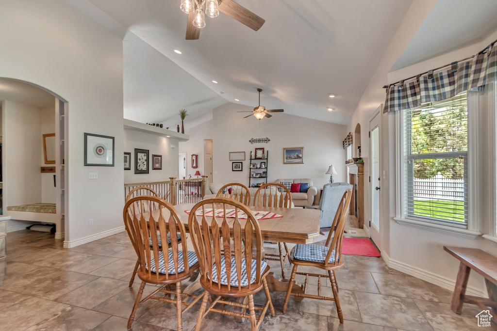 Dining room with a ceiling fan, vaulted ceiling, arched walkways, recessed lighting, and baseboards