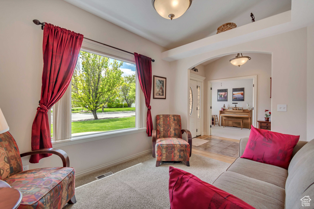 Living area featuring arched walkways and baseboards