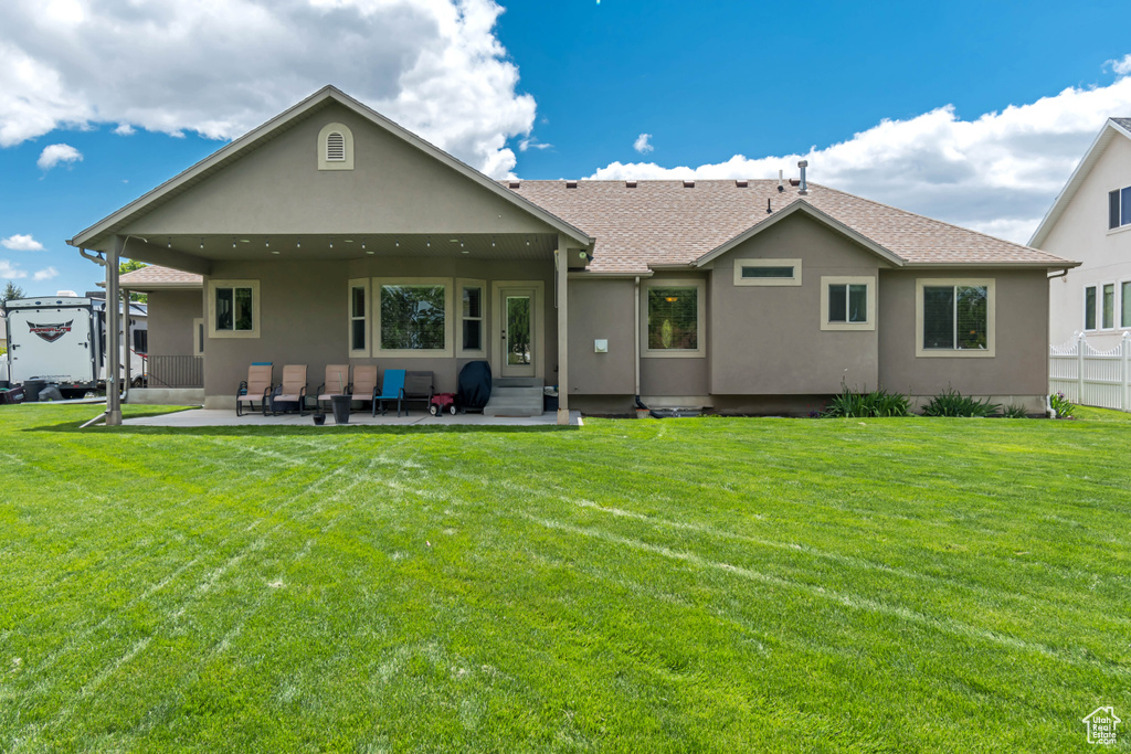 Back of house with a patio area, stucco siding, entry steps, and roof with shingles