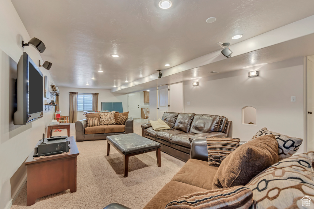 Carpeted living room with recessed lighting