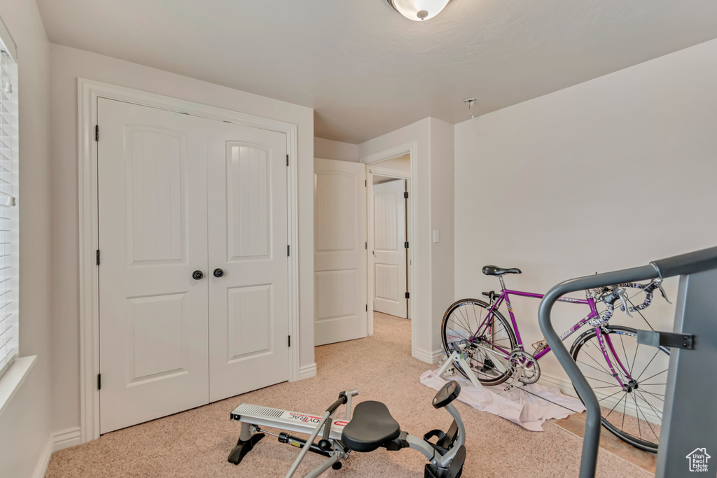Workout room with carpet and baseboards