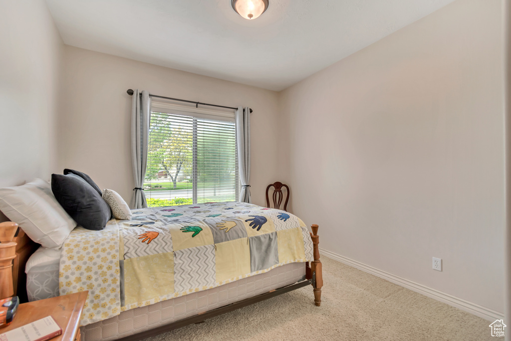Bedroom featuring carpet floors and baseboards