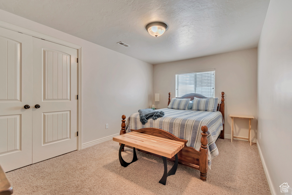 Carpeted bedroom featuring baseboards