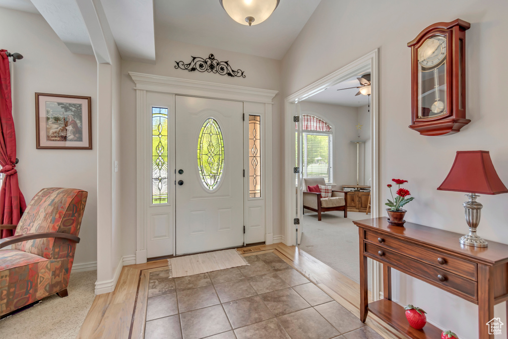 Entrance foyer featuring ceiling fan, baseboards, and wood finished floors