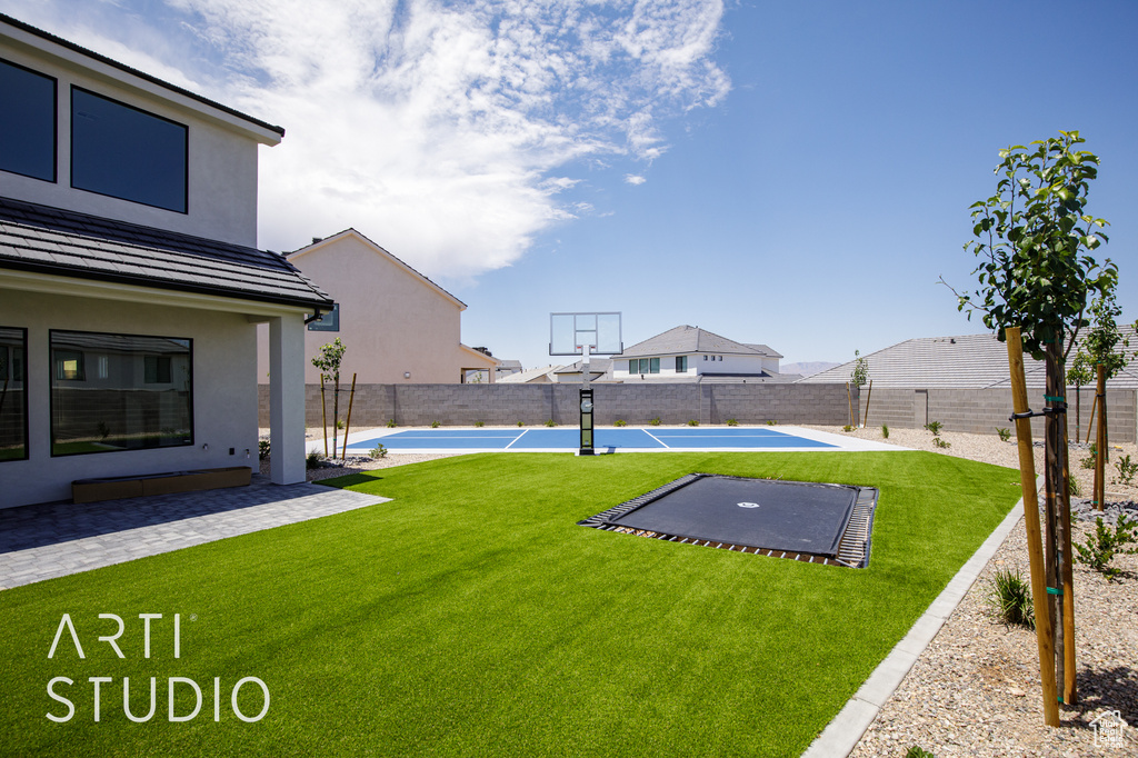 View of yard featuring basketball court