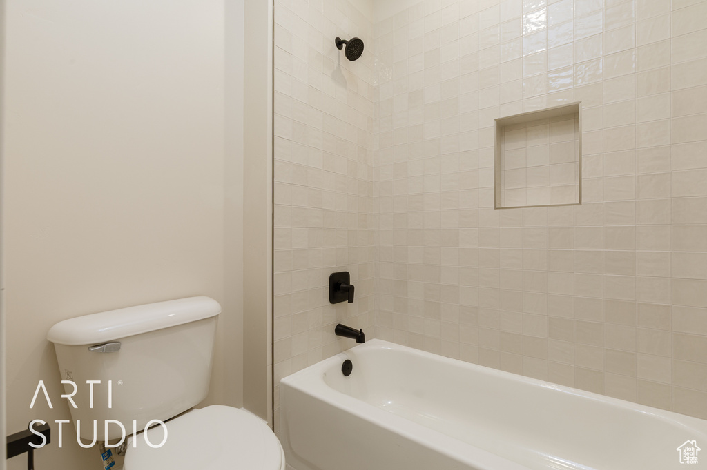 Bathroom featuring toilet and shower / tub combination