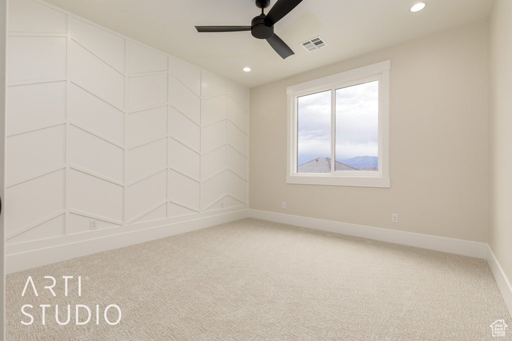 Empty room featuring carpet floors, ceiling fan, baseboards, and recessed lighting