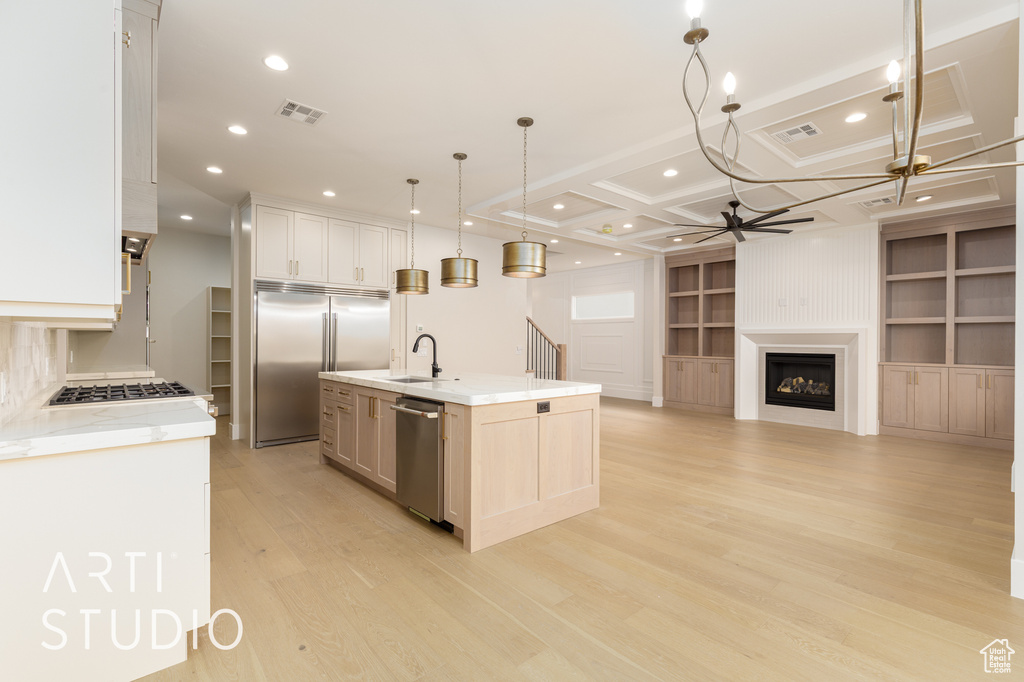 Kitchen with stainless steel appliances, a sink, a ceiling fan, light wood finished floors, and recessed lighting