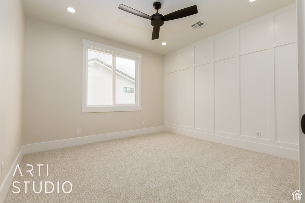 Carpeted spare room featuring a ceiling fan, recessed lighting, and baseboards