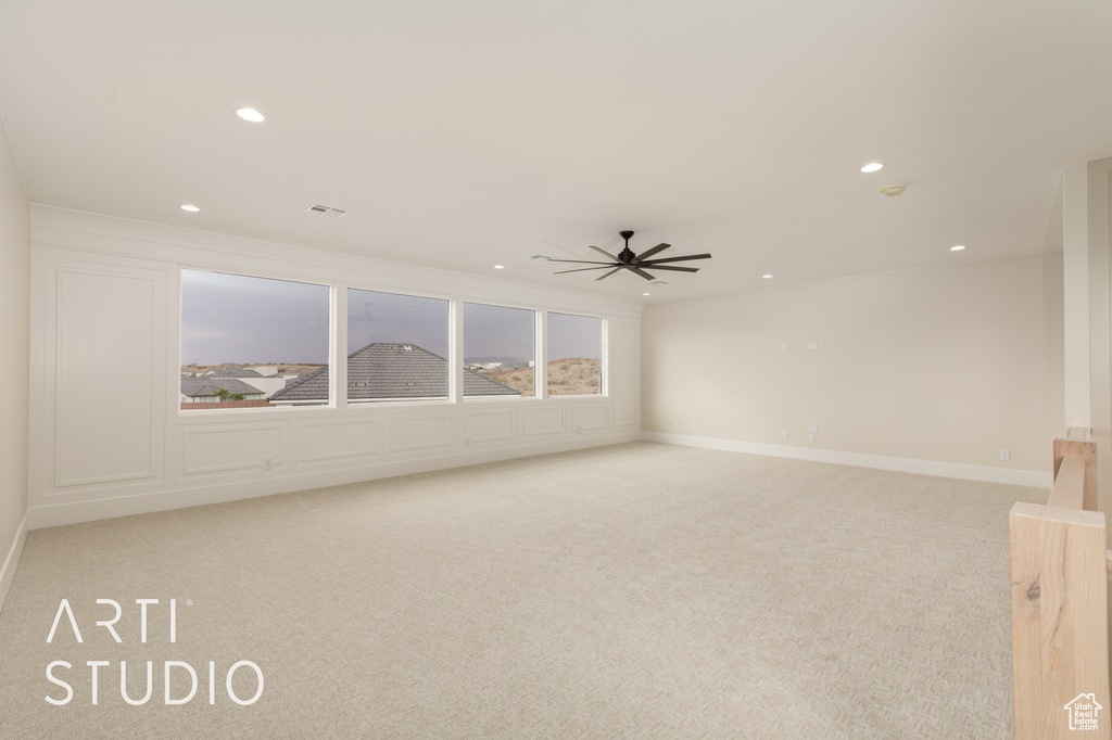 Unfurnished room with light colored carpet, ceiling fan, recessed lighting, and baseboards