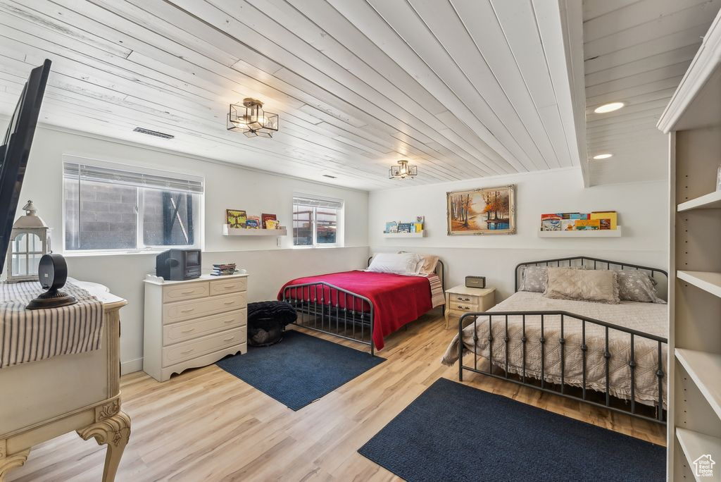 Bedroom with wood finished floors, wooden ceiling, and recessed lighting