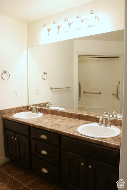 Bathroom with double vanity and tile patterned floors