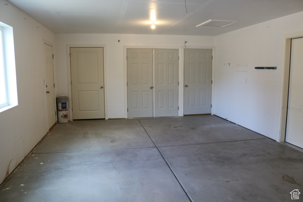 Unfurnished bedroom with concrete flooring