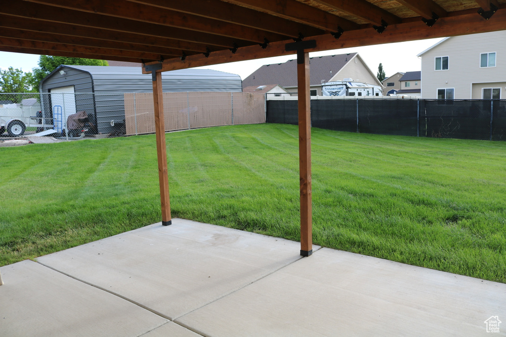View of yard with a patio and an outbuilding