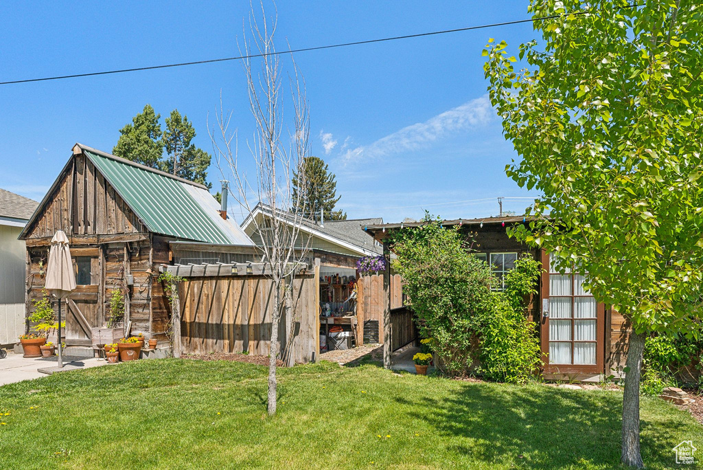 View of grassy yard with an outdoor structure