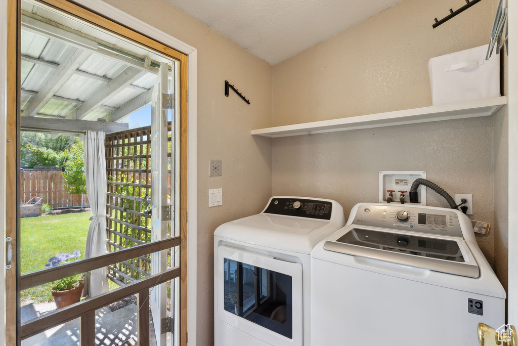 Washroom with washer and clothes dryer