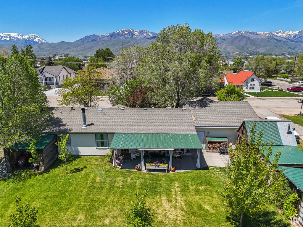 Aerial view of property and surrounding area featuring a mountainous background