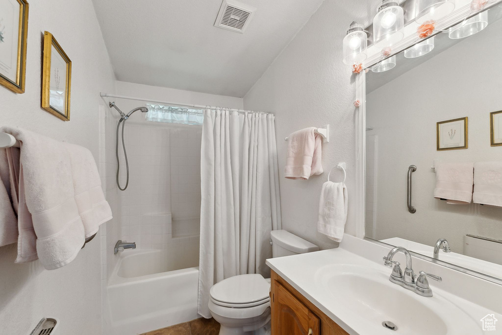 Full bath featuring toilet, shower / bath combo, and vanity