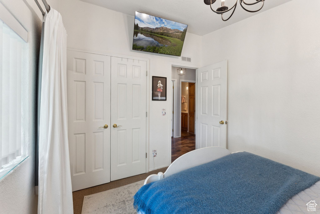 Bedroom featuring a chandelier and a closet