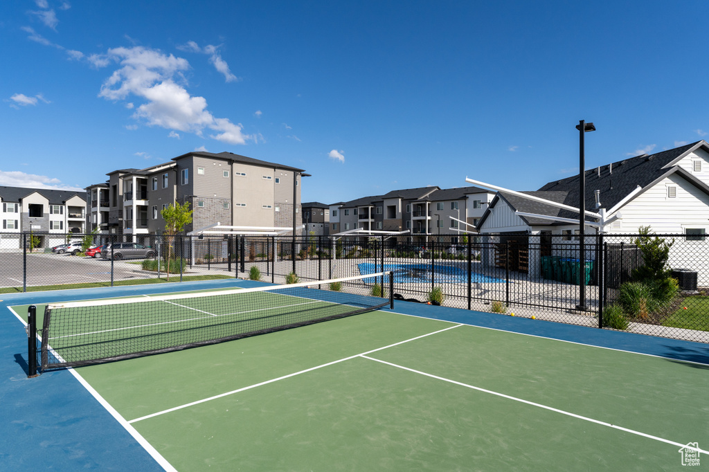 View of tennis court featuring a residential view
