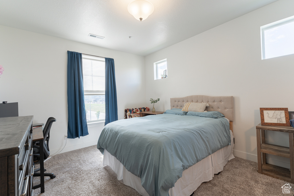 Bedroom featuring carpet, baseboards, and an office area