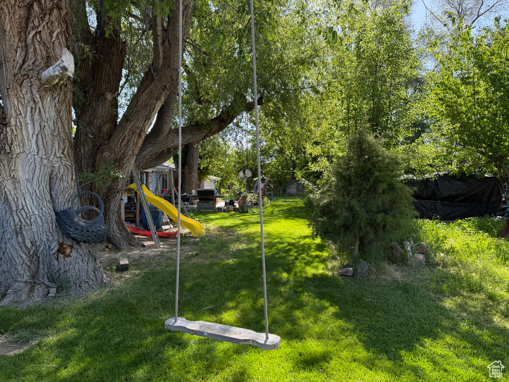 View of green lawn featuring a playground