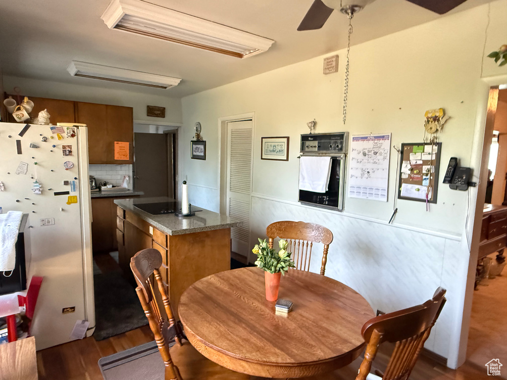 Dining space featuring wood finished floors and ceiling fan