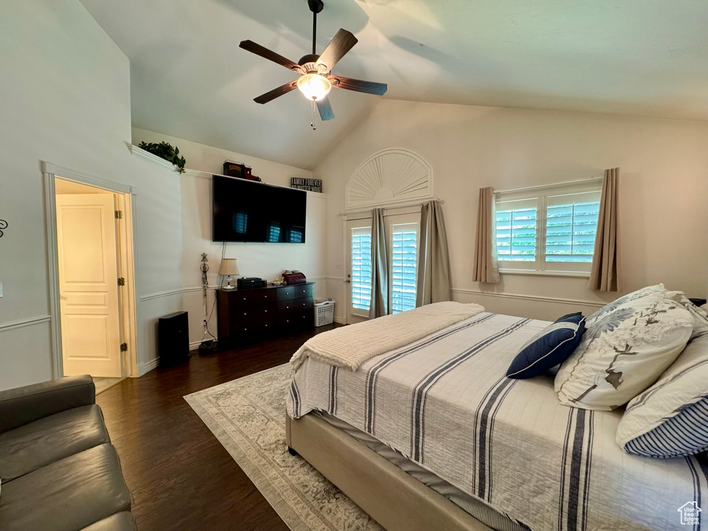 Bedroom featuring wood finished floors, a ceiling fan, access to exterior, and high vaulted ceiling