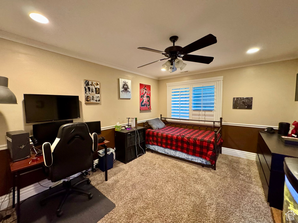 Carpeted bedroom featuring ornamental molding, recessed lighting, a desk, baseboards, and ceiling fan