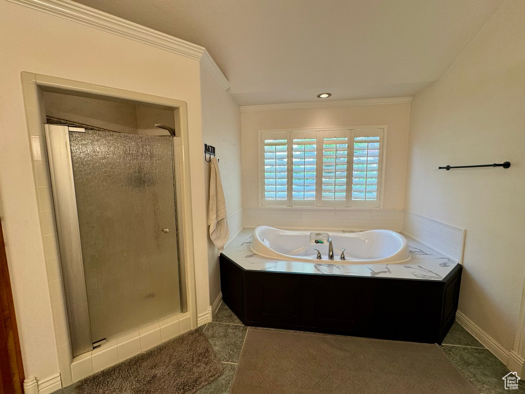 Full bath featuring a shower stall, a bath, crown molding, and baseboards