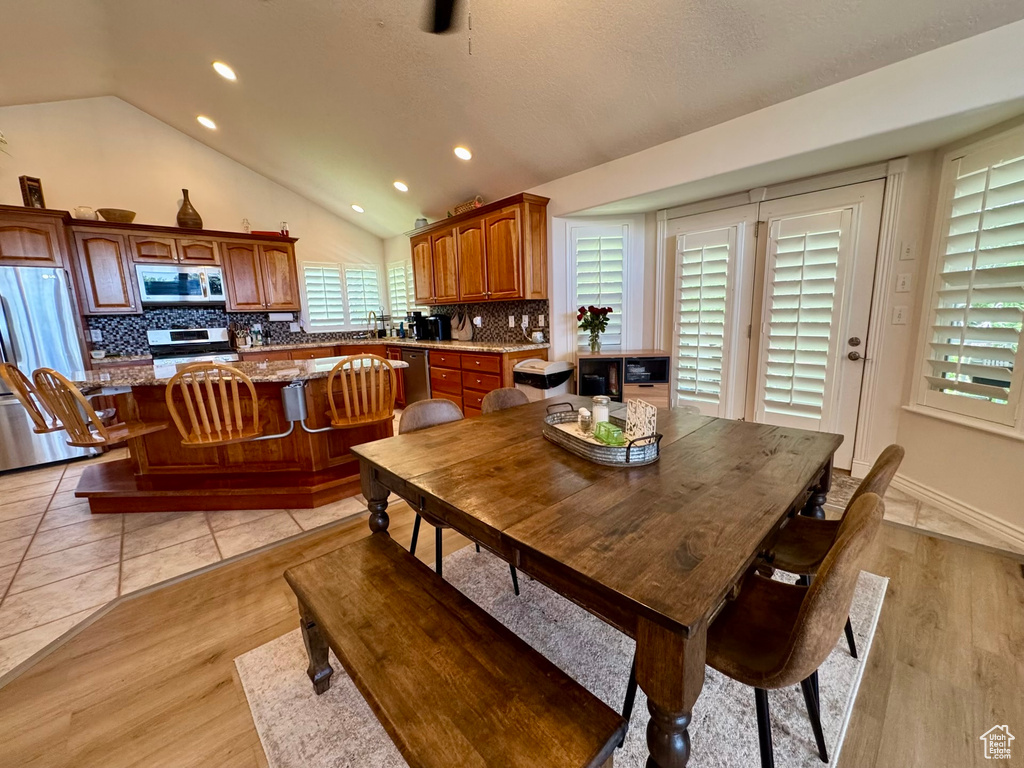 Dining room with vaulted ceiling, recessed lighting, and light wood-style floors