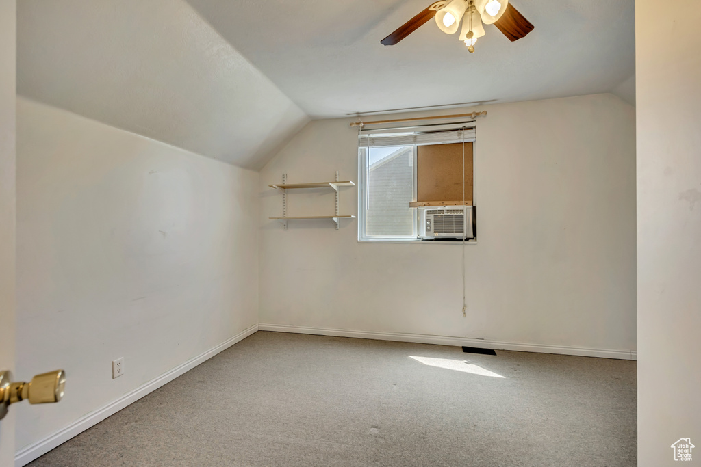 Bonus room featuring vaulted ceiling, ceiling fan, carpet flooring, and baseboards