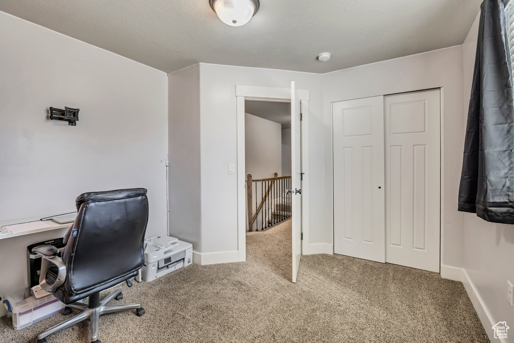 Carpeted office space with baseboards