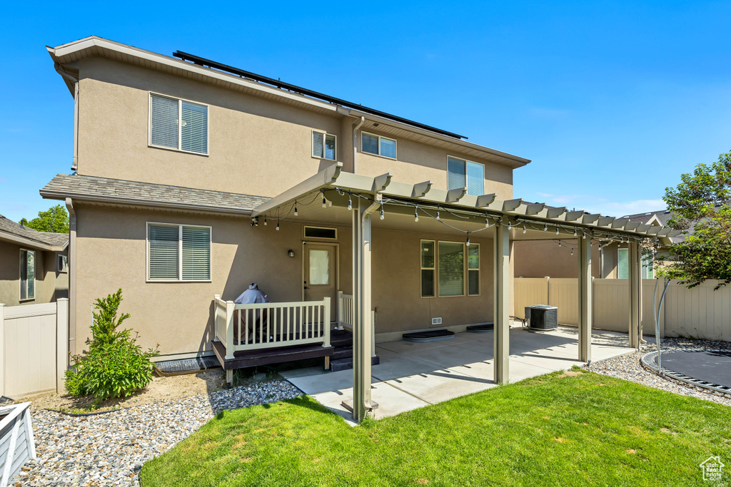 Back of property featuring a pergola, stucco siding, a patio area, and central AC unit