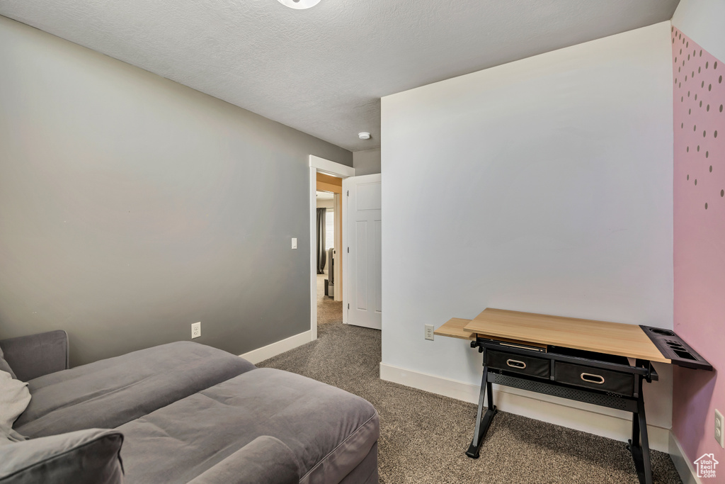 Carpeted bedroom featuring baseboards