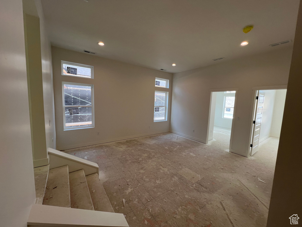 Empty room featuring healthy amount of natural light, recessed lighting, and a smoke detector
