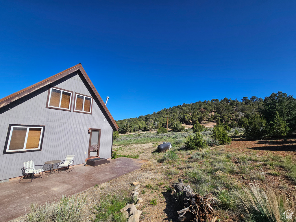 View of side of home with a patio area