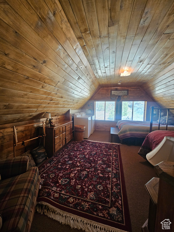 Carpeted bedroom with wooden ceiling, vaulted ceiling, and wood walls