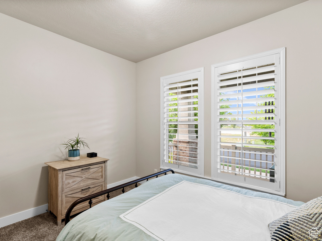 Carpeted bedroom featuring baseboards
