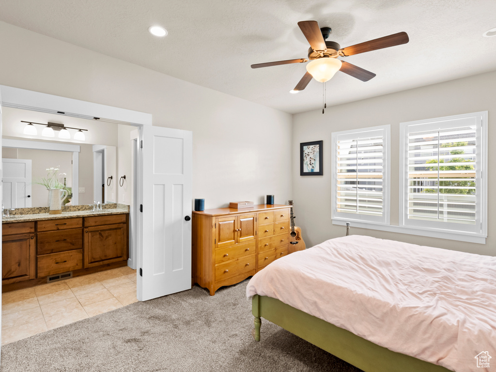 Bedroom featuring light carpet, connected bathroom, ceiling fan, a sink, and recessed lighting