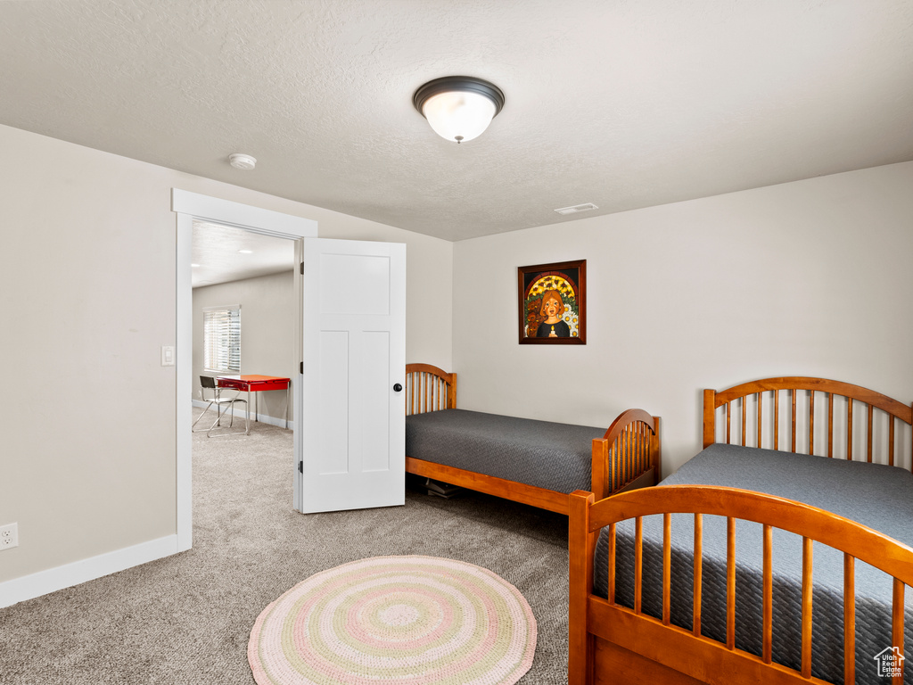 Carpeted bedroom featuring baseboards