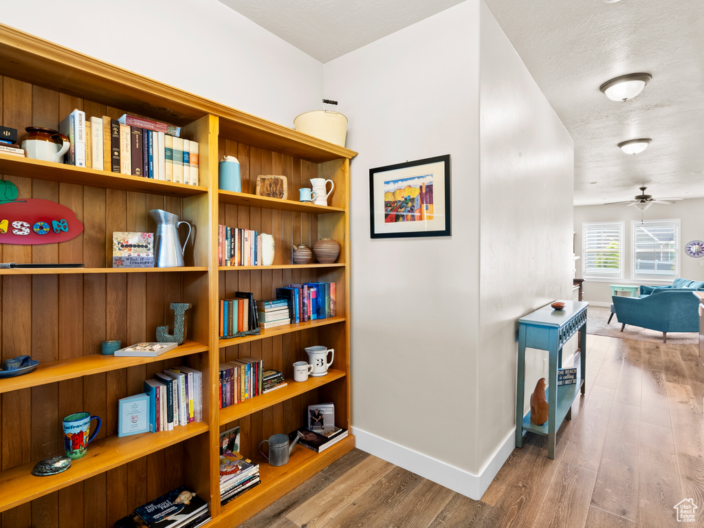 Hallway featuring wood finished floors and baseboards