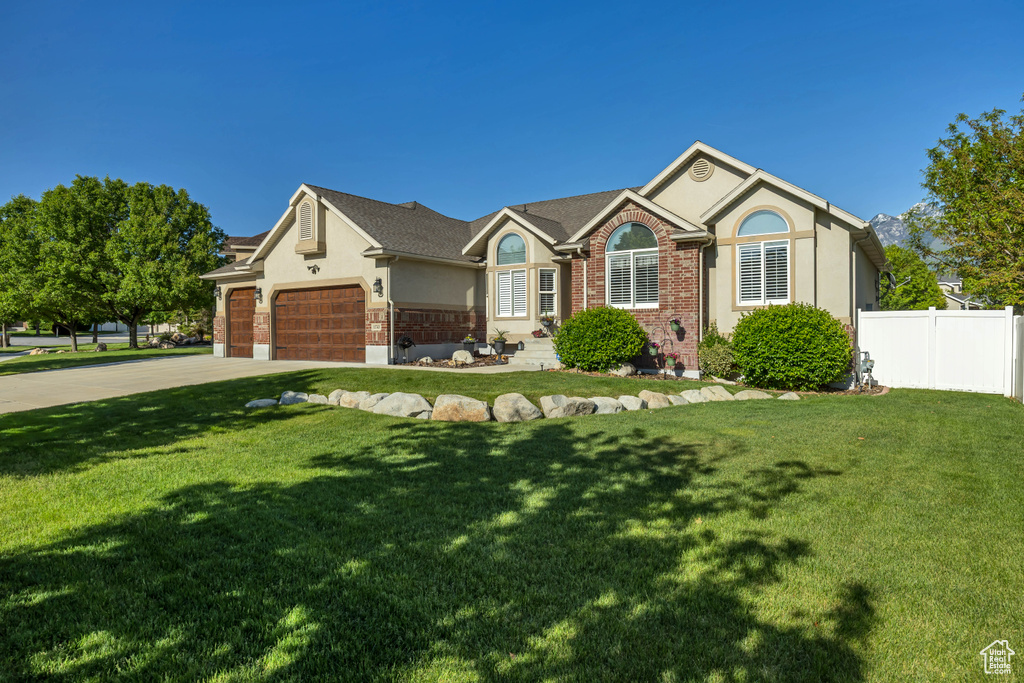 Single story home featuring stucco siding, a garage, and concrete driveway