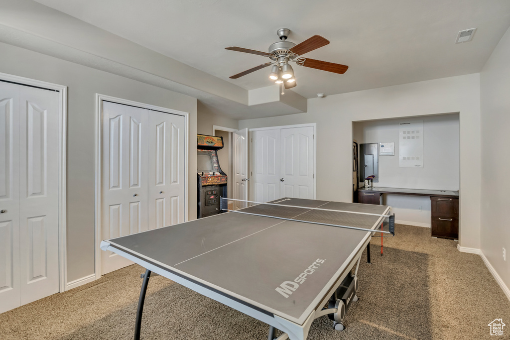 Playroom featuring carpet, a ceiling fan, and baseboards