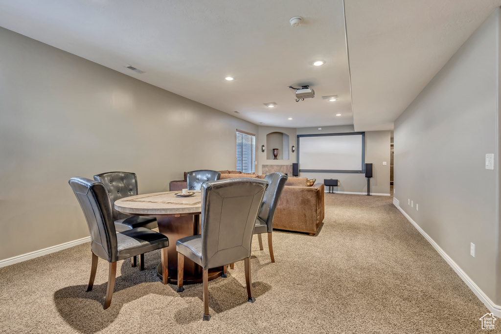 Home theater with light colored carpet, baseboards, and recessed lighting