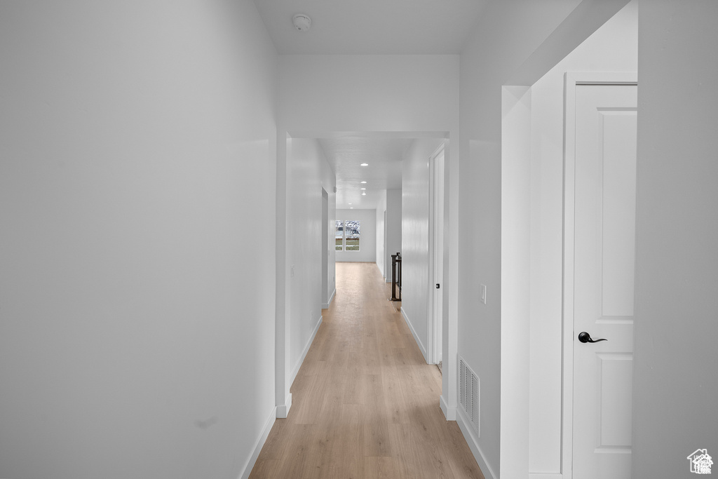 Hall featuring light wood-style floors and baseboards