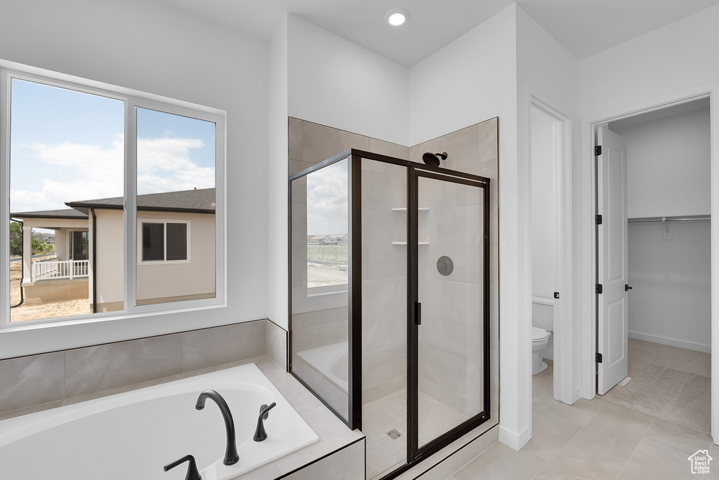 Bathroom featuring a shower stall, a garden tub, toilet, and recessed lighting