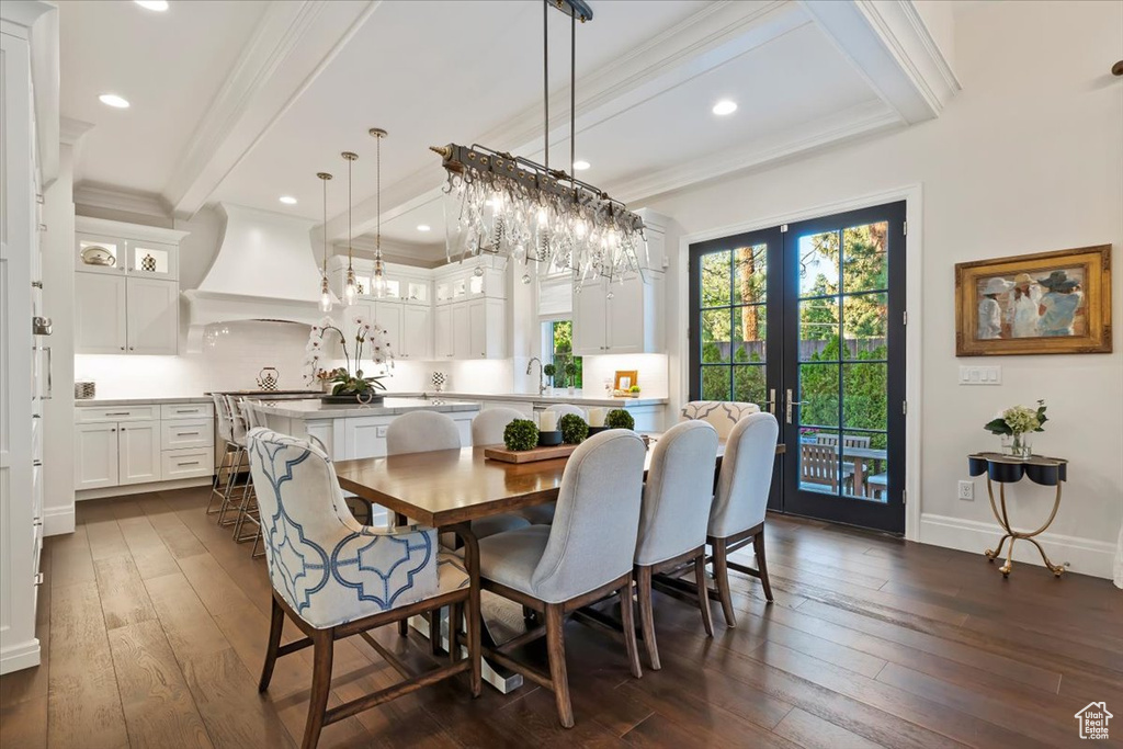 Dining room featuring beam ceiling, dark wood-style floors, french doors, ornamental molding, and recessed lighting