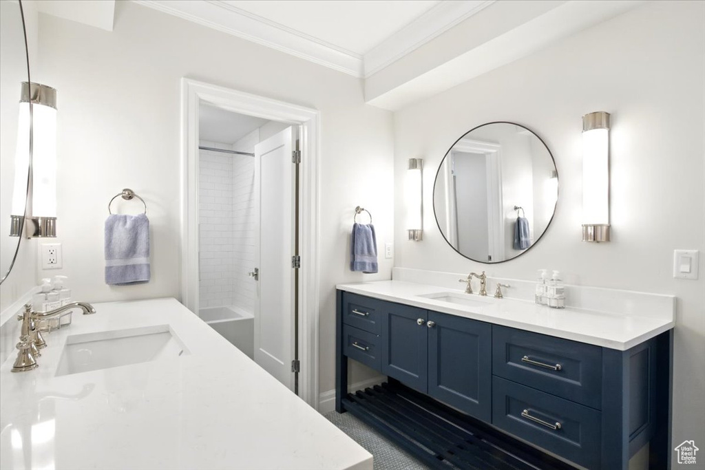 Full bathroom featuring vanity, crown molding, and shower / bathtub combination